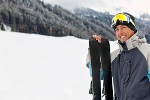 happy skier smiling with his skiis in the trail.jpeg